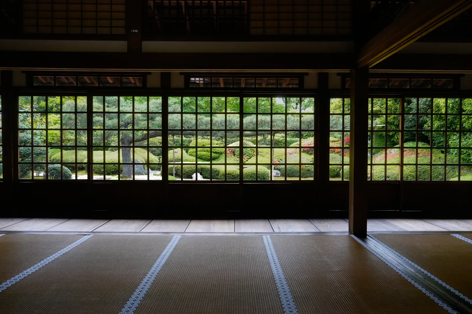 Garden seen through wooden lattice windows from a tatami room at a Zen temple in Kyoto