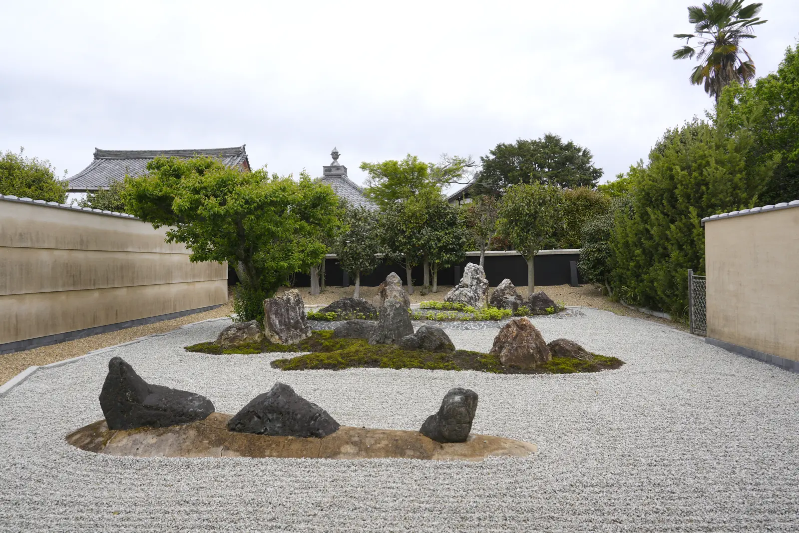 A dry garden at a Zen temple in Kyoto, with groups of stones and moss set in white gravel