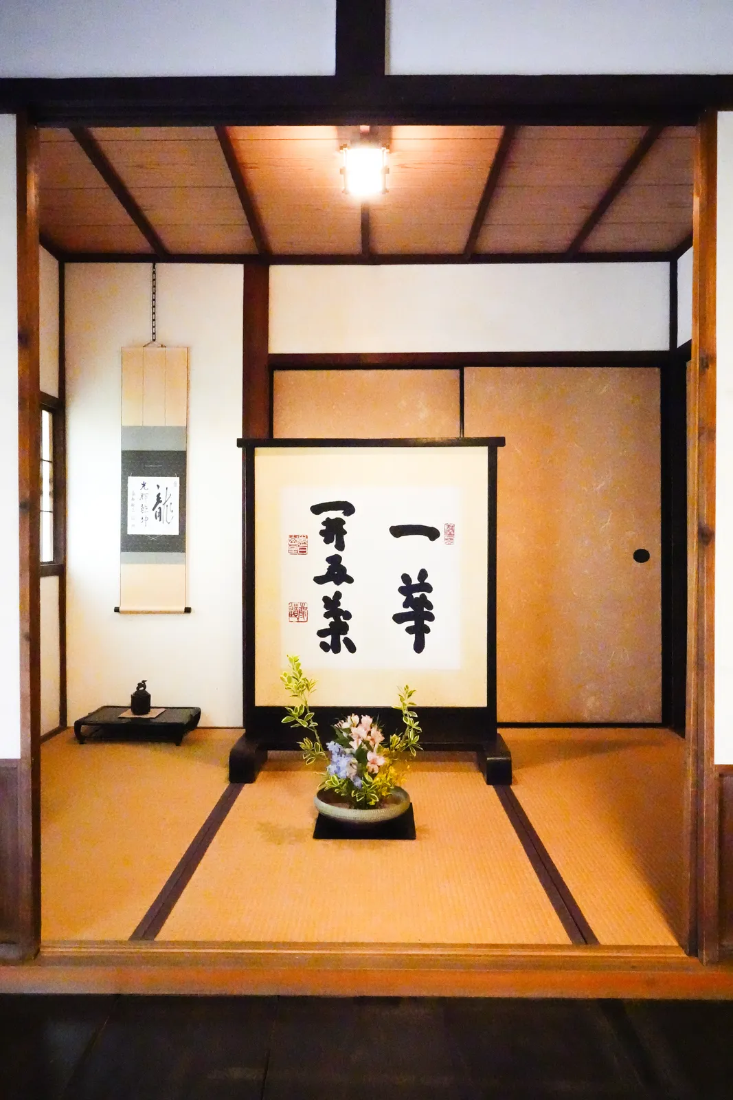 Tokonoma alcove with a hanging scroll and flowers in a temple hall at a Zen temple in Kyoto
