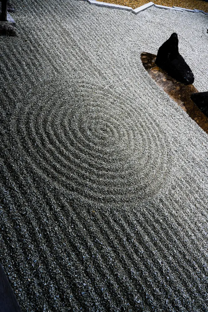 Raked gravel and stones in a Zen garden in Kyoto