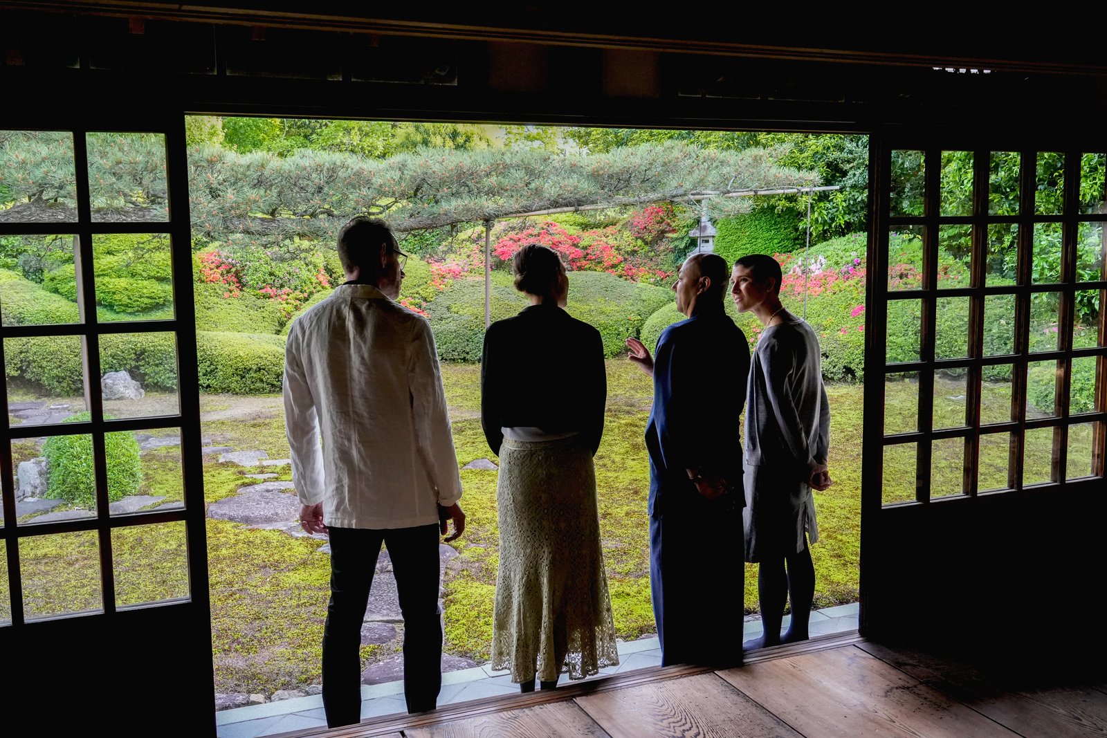Guests taking in the moss and azalea garden from the temple hall